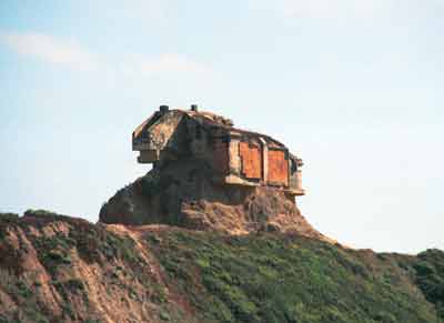 This house was between the road and the ocean. Fixer-upper?