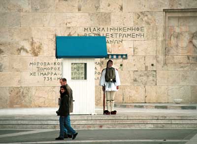 Guard in traditional dress at a government building.