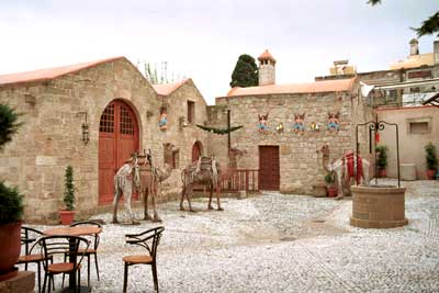 This was a courtyard in front of a cafe (to the right). Down the steps behind the camels (fake), was a creche.