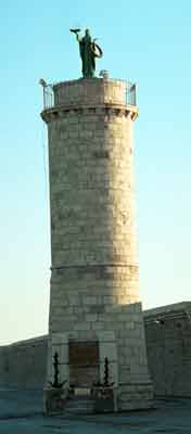 A statue of Santa Fermina guards the port.